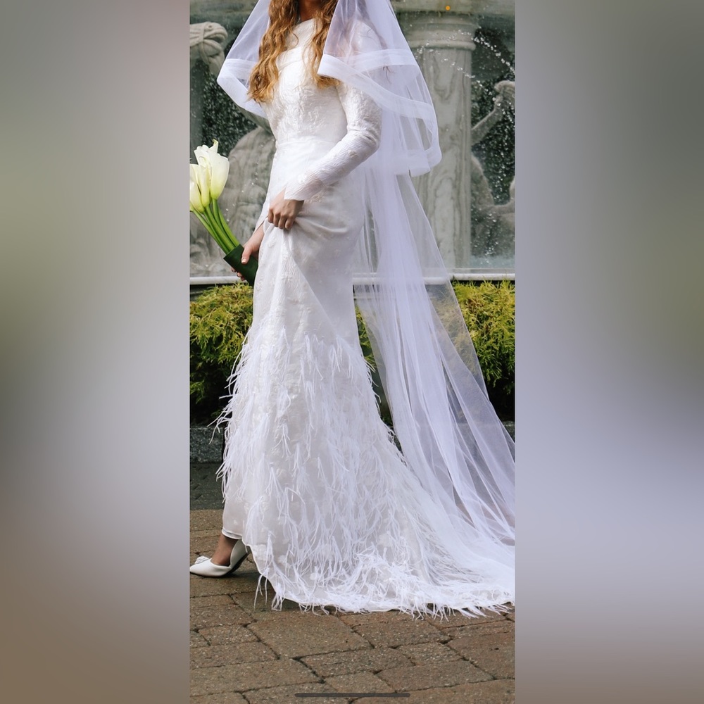 Gorgous custom wedding gown with soft feather details.